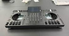 Behringer ANIMA prototype with central screen, four-channel mixer and empty jog-wheel and pad openings